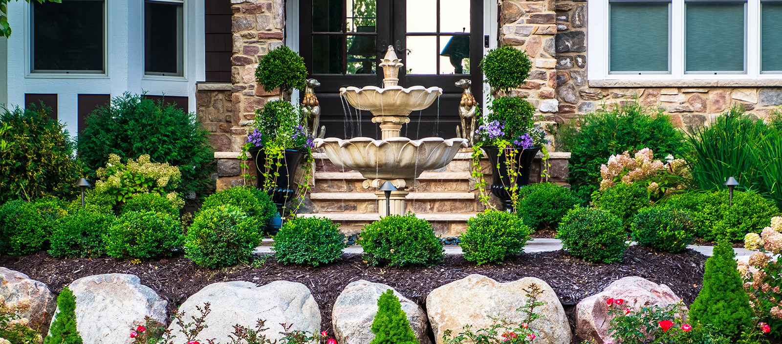 Front landscaping with water feature.
